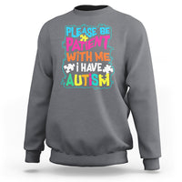Dark heather gray autism sweatshirt with colorful “Please be patient with me” graphic
