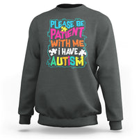Charcoal gray autism sweatshirt with colorful “Please be patient with me” graphic