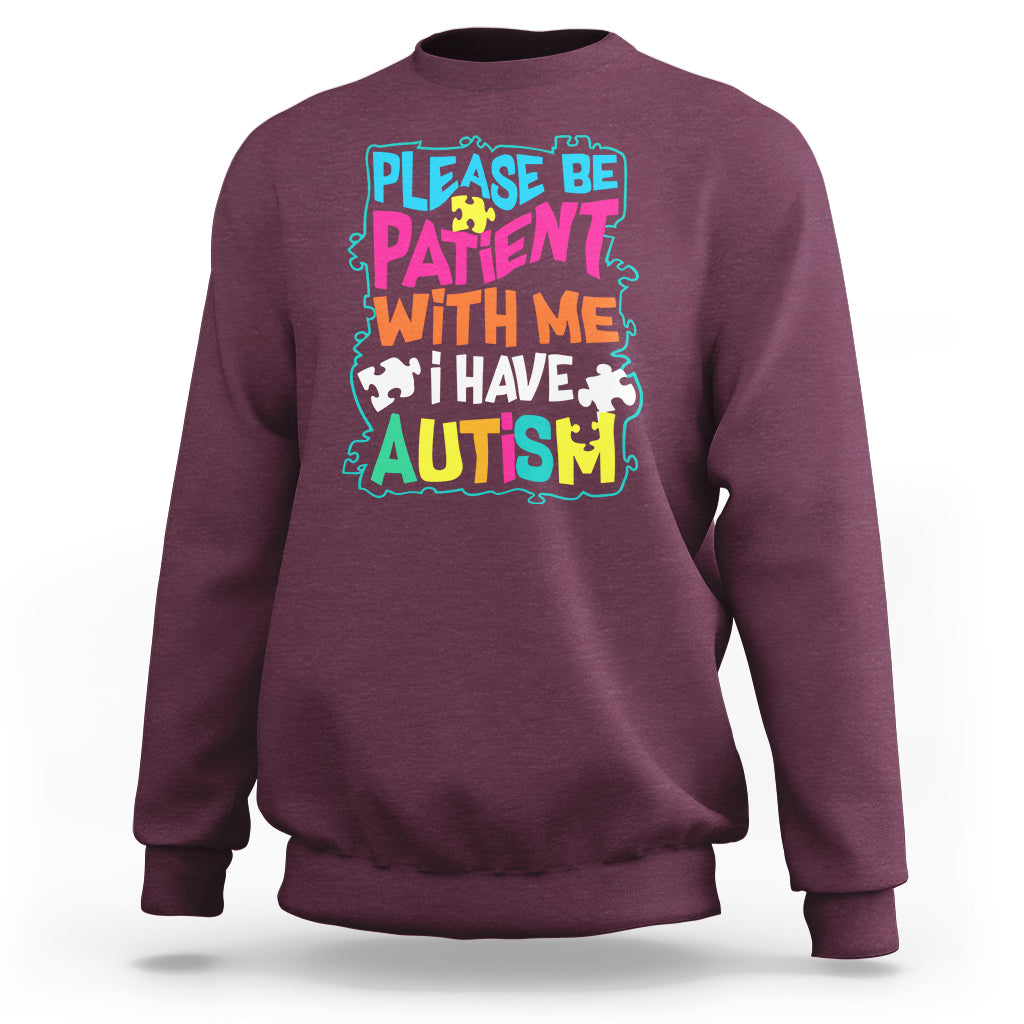 Maroon autism sweatshirt with colorful “Please be patient with me” graphic