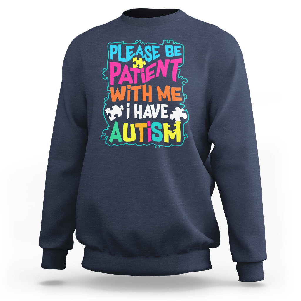 Dark blue autism sweatshirt with colorful “Please be patient with me” graphic