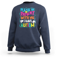 Dark blue autism sweatshirt with colorful “Please be patient with me” graphic
