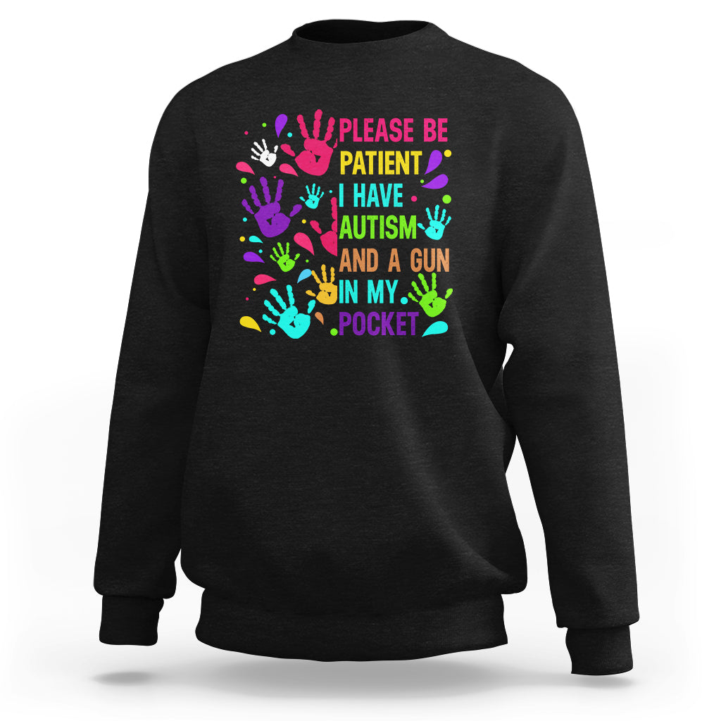 Black sweatshirt with colorful handprint text: “Please be patient... gun in my pocket”.