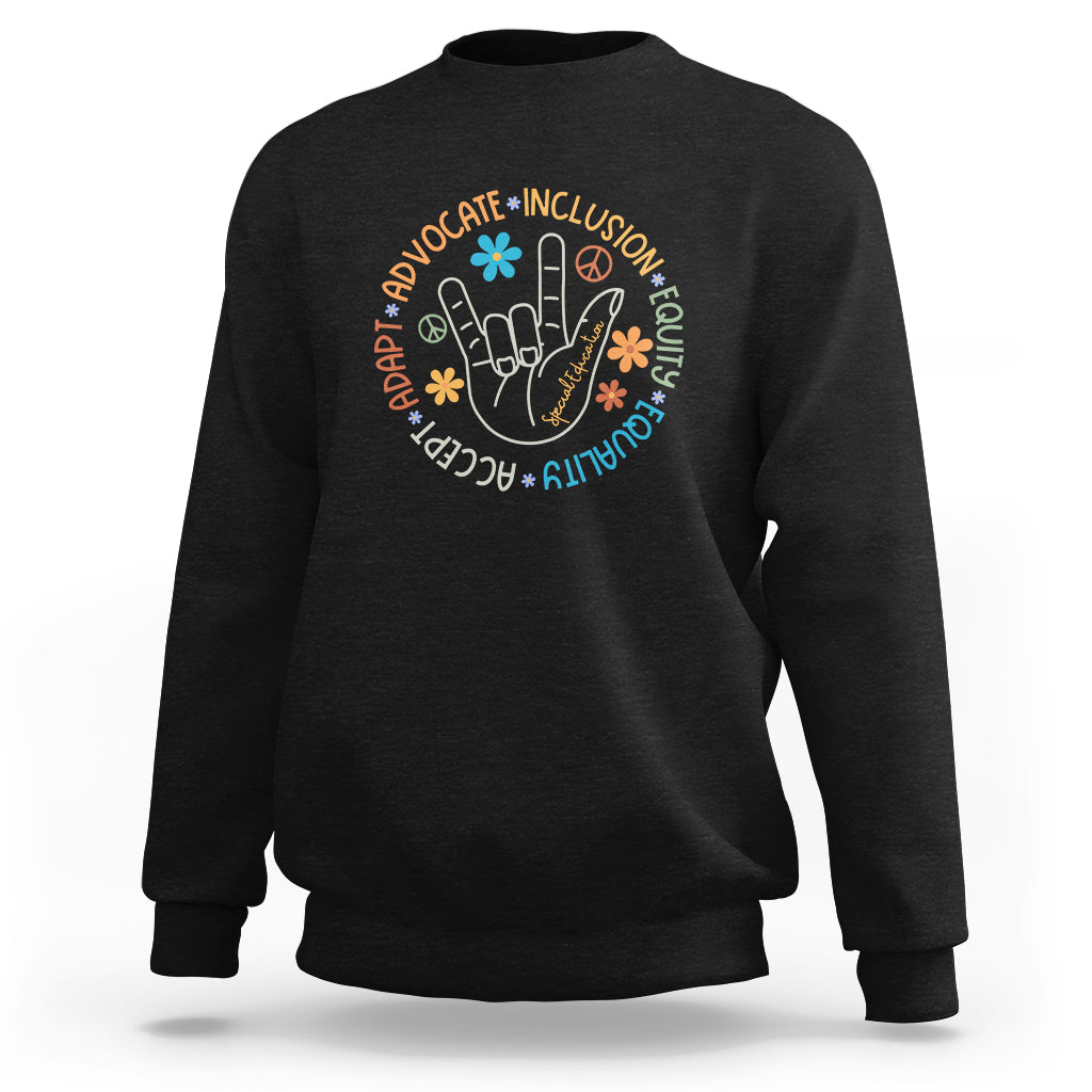 Black crewneck sweatshirt with long sleeves and colorful inclusion-themed graphic on front