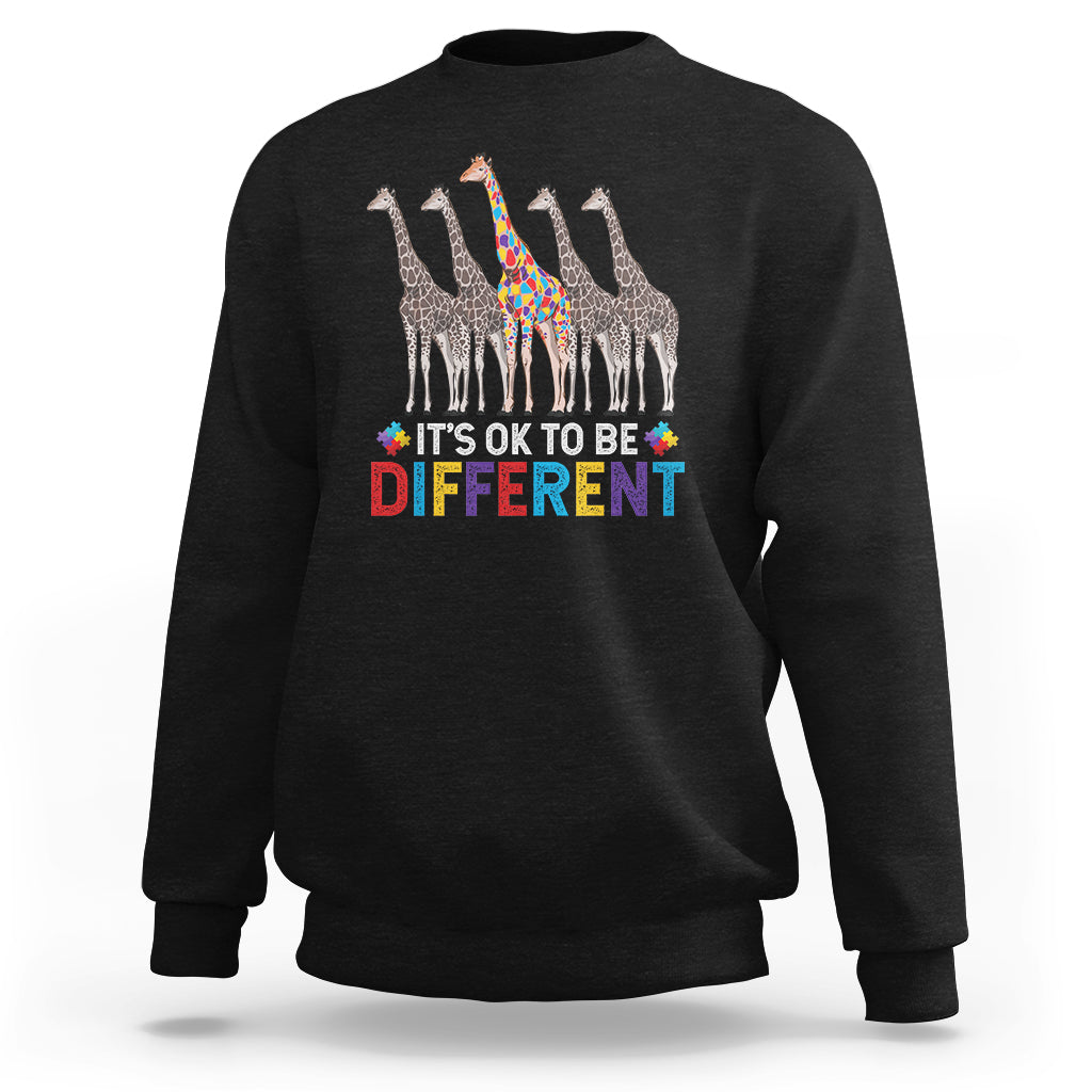 Black crewneck sweatshirt with colorful giraffe graphic and “It’s OK to be Different” text.