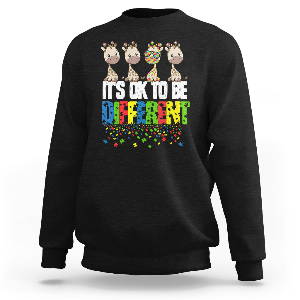 Black sweatshirt with giraffe graphic and colorful “It’s ok to be different” text