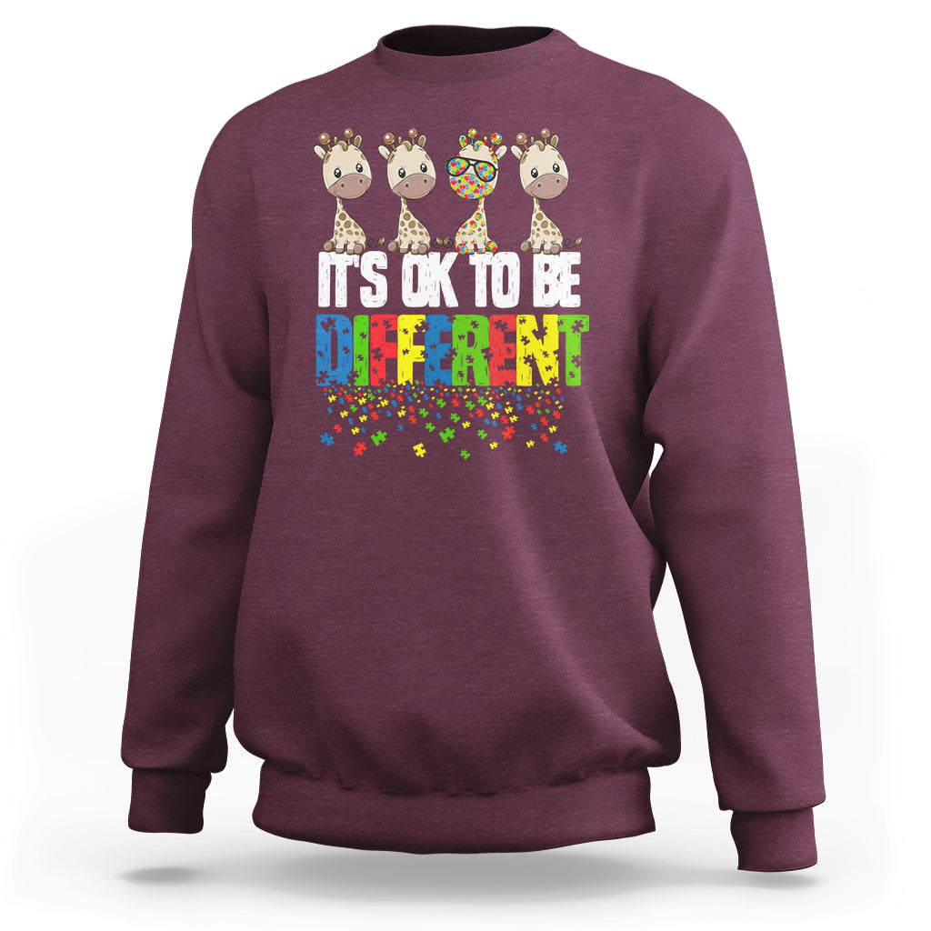 Maroon sweatshirt with giraffe graphic and colorful “It’s ok to be different” text