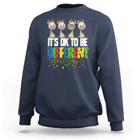 Navy blue sweatshirt with giraffe graphic and colorful “It’s ok to be different” text