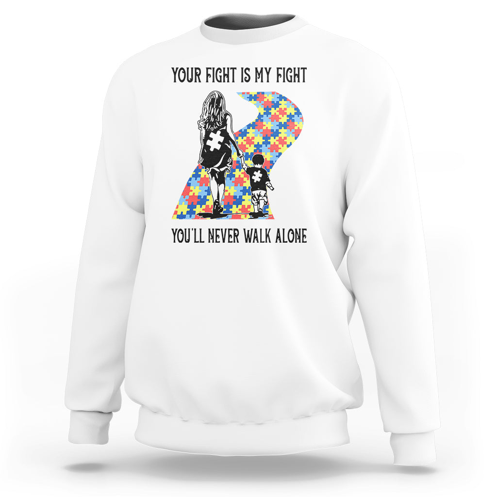 White crewneck sweatshirt with autism mom graphic and “You’ll never walk alone” text