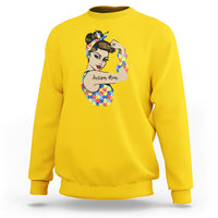 Yellow crewneck sweatshirt with autism-themed face graphic on chest.
