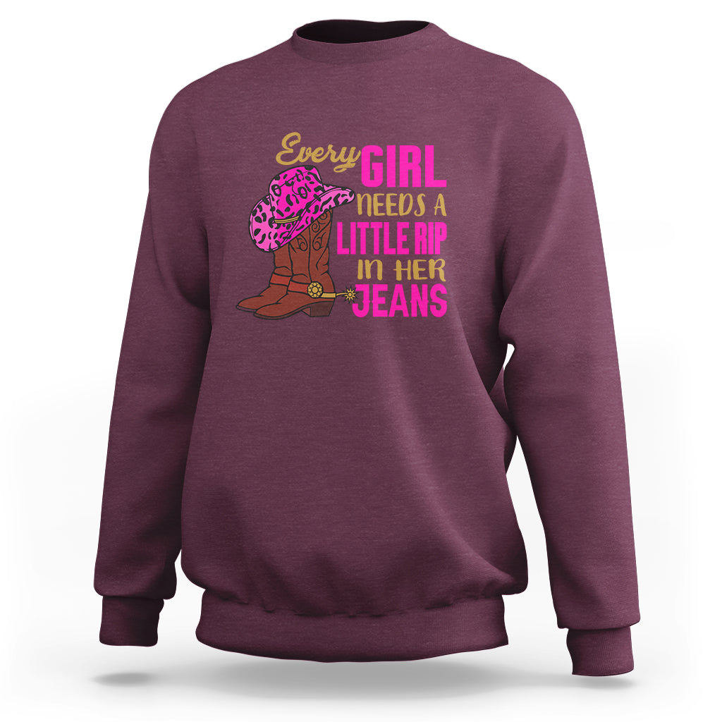 Maroon crewneck sweatshirt with colorful “Every GIRL needs a little rip in her jeans” graphic
