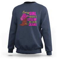 Navy crewneck sweatshirt with colorful “Every GIRL needs a little rip in her jeans” graphic