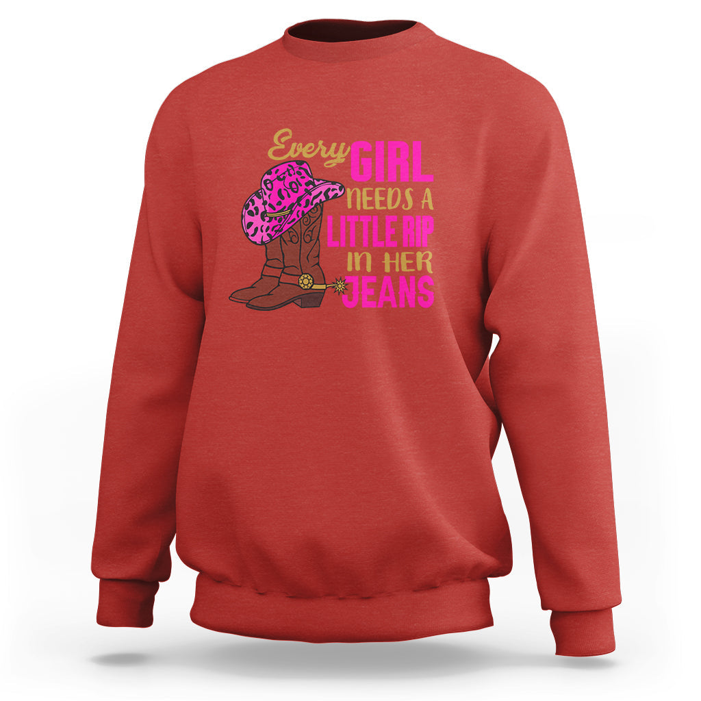 Red crewneck sweatshirt with colorful “Every GIRL needs a little rip in her jeans” graphic