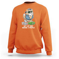 Orange sweatshirt with cat holding a green leaf and “I Like Weed” front print