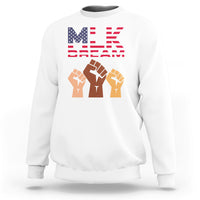White crewneck sweatshirt with “MLK Day Dream” graphic and raised-fist design on chest