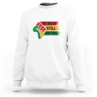White crewneck sweatshirt with front graphic "His Dream Still Matters"