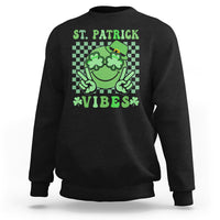 Black St. Patrick sweatshirt with green shamrock character and text 'VIBES'