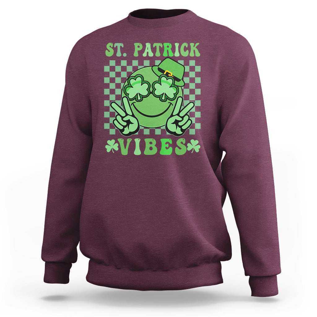 Maroon St. Patrick sweatshirt with green shamrock character and text 'VIBES'