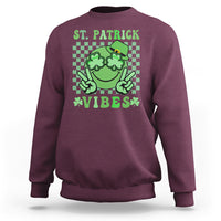 Maroon St. Patrick sweatshirt with green shamrock character and text 'VIBES'