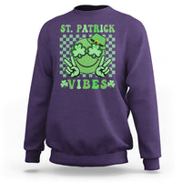 Purple St. Patrick sweatshirt with green shamrock character and text 'VIBES'