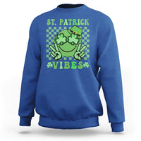 Royal blue St. Patrick sweatshirt with green shamrock character and text 'VIBES'