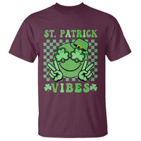 St. Patrick's Day t-shirt in maroon with green shamrock face and 'VIBES' graphic