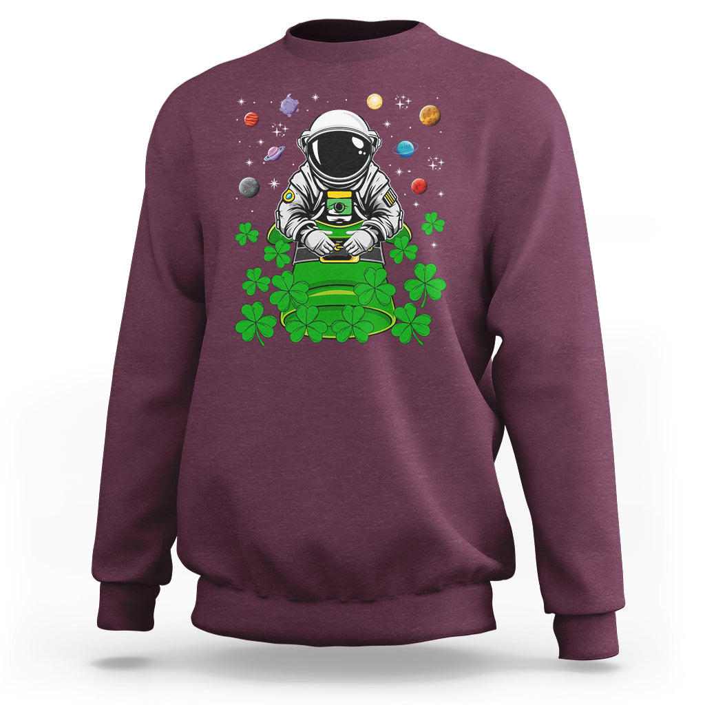 Maroon crewneck sweatshirt with astronaut leprechaun space-themed graphic on front