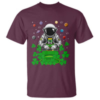 Maroon astronaut St. Patrick’s graphic T-shirt with leprechaun clover print