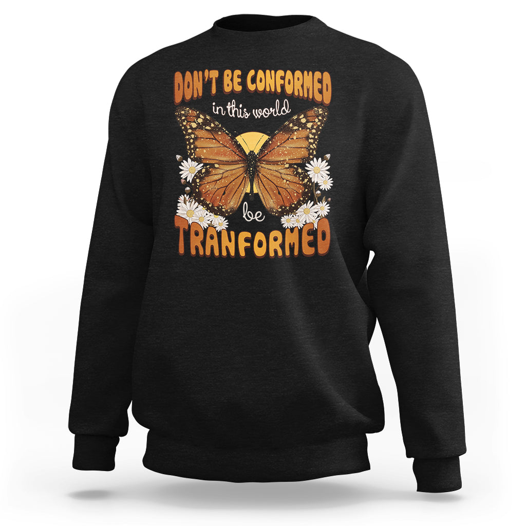 Black crewneck sweatshirt with front butterfly graphic and “be transformed” inspirational text