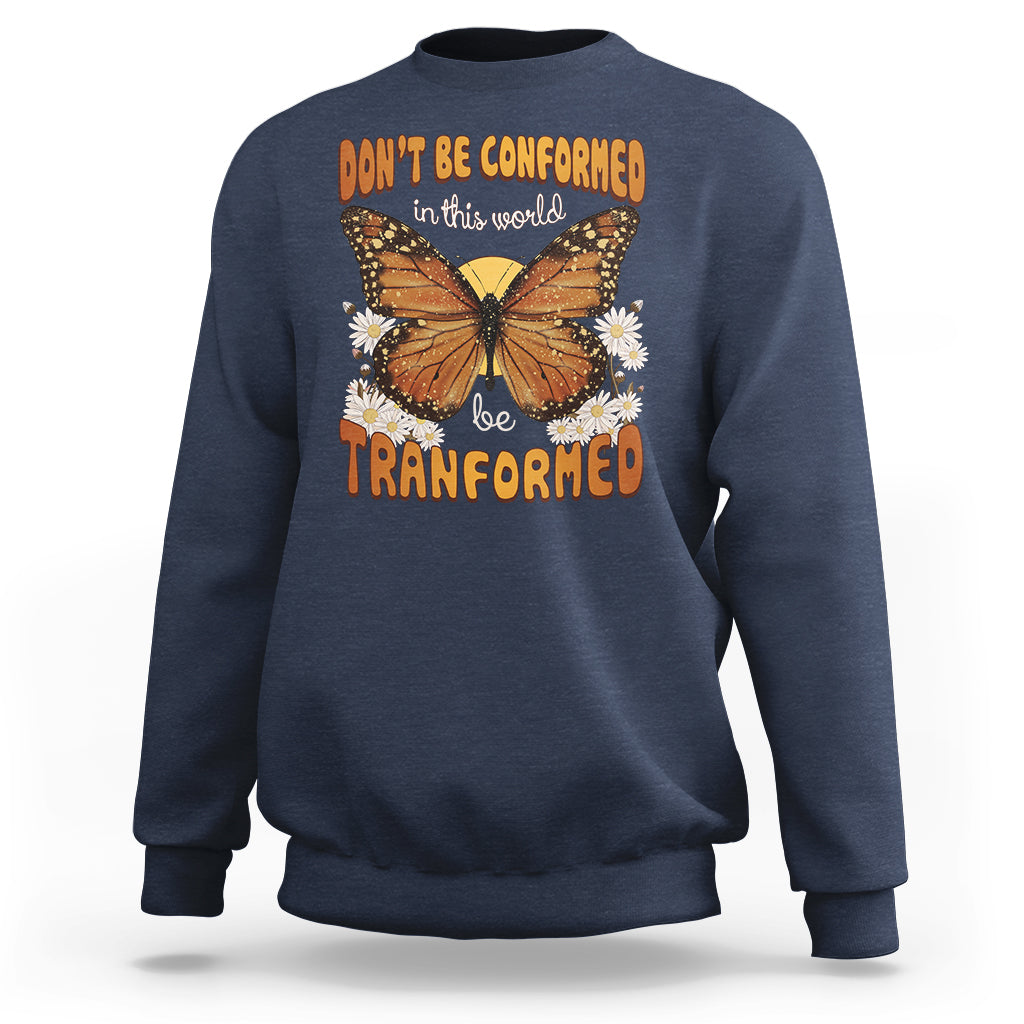 Navy crewneck sweatshirt with front butterfly graphic and “be transformed” inspirational text
