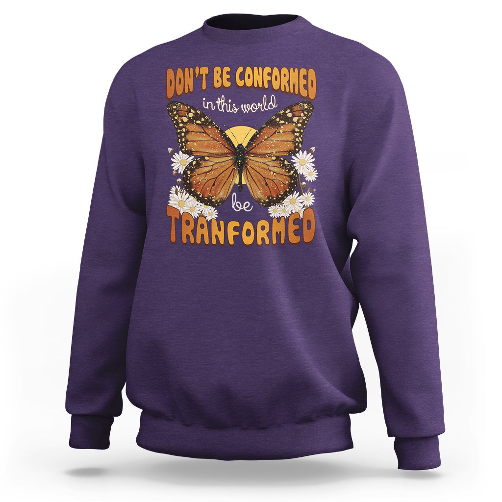 Purple crewneck sweatshirt with front butterfly graphic and “be transformed” inspirational text