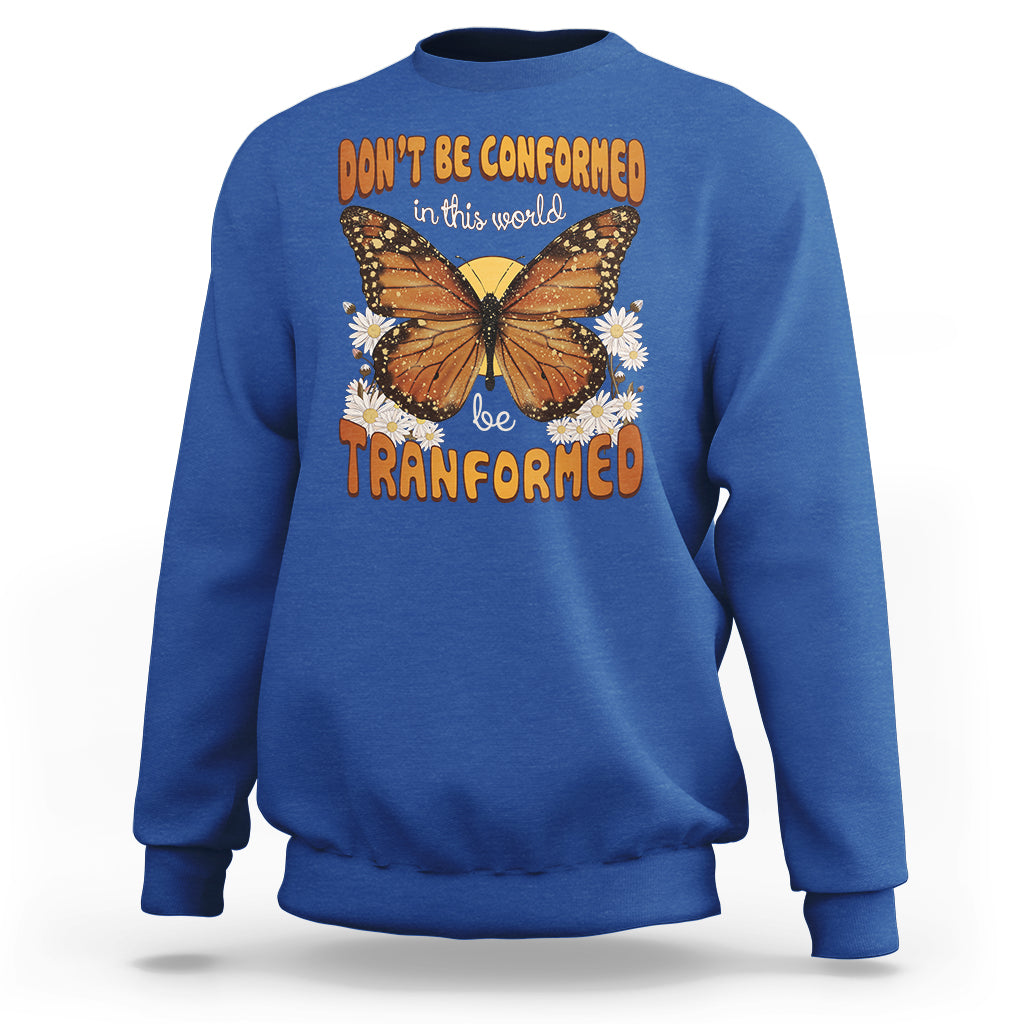 Royal blue crewneck sweatshirt with front butterfly graphic and “be transformed” text