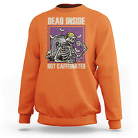 Orange Halloween skeleton sweatshirt with front “Dead Inside, But Caffeinated” graphic.
