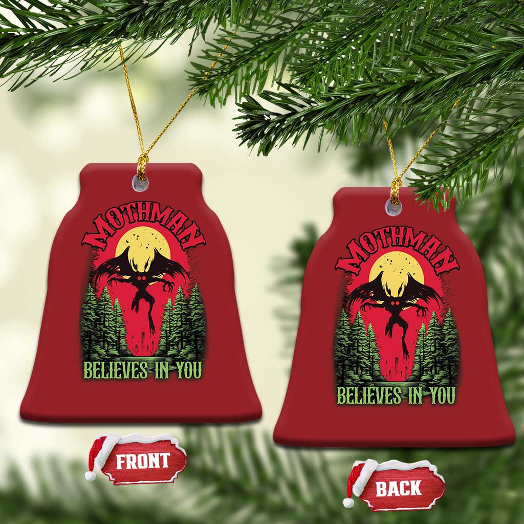 Red bell-shaped Mothman Christmas ornament, front and back labels, “Believes in You”