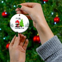 Round ceramic cat ornament held in hands, with “Everything is fine” message