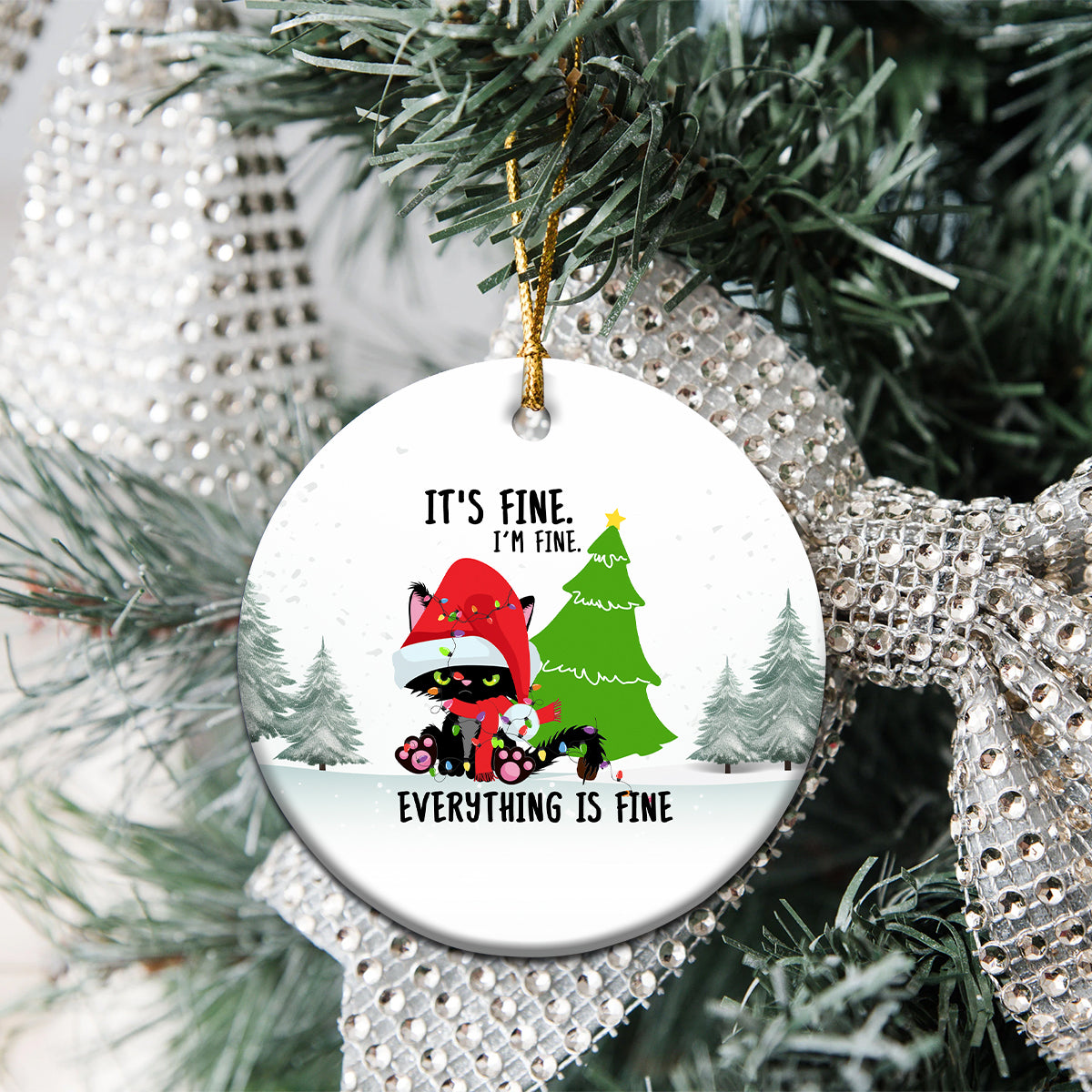 Round ceramic cat Christmas ornament on tree branch with “Everything is fine” text
