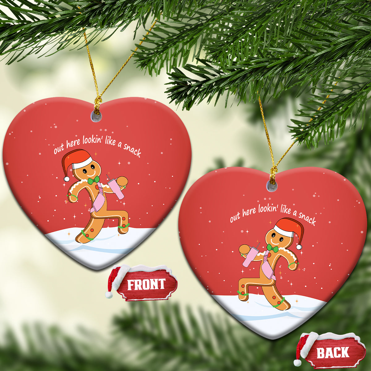 Red heart-shaped ceramic ornament with gingerbread runner graphic and gold hanging loop.