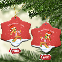 Red heart-shaped ceramic ornament featuring gingerbread runner graphic and gold hanging loop.