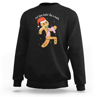 Black crewneck sweatshirt with colorful gingerbread man graphic on the chest