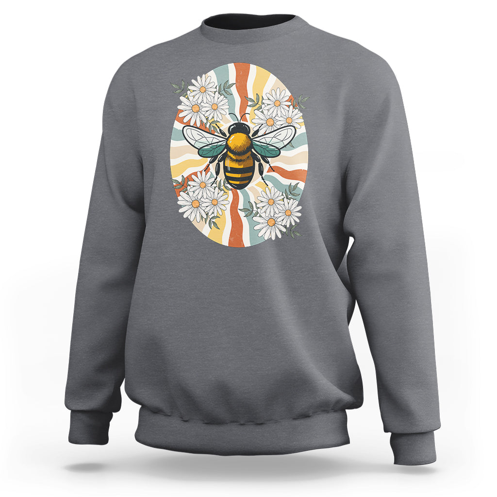 Charcoal gray crewneck sweatshirt with bee-and-daisy graphic on front