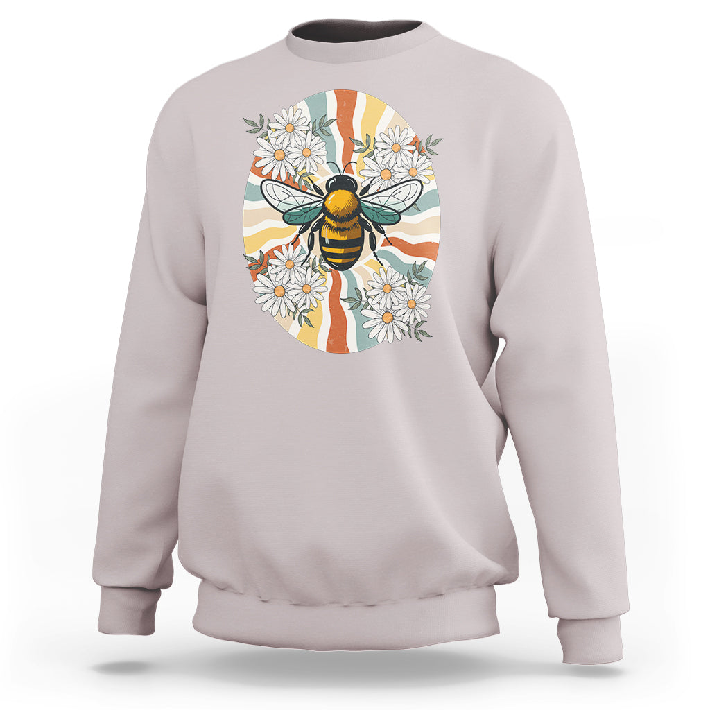Ice gray crewneck sweatshirt with bee-and-daisy graphic on front