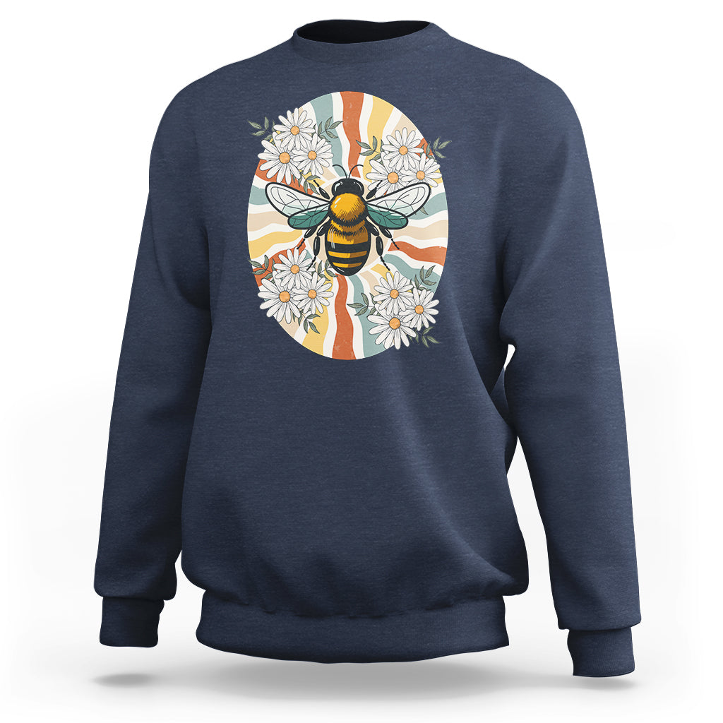 Navy crewneck sweatshirt with bee-and-daisy graphic on front