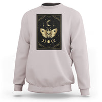 White crewneck sweatshirt with framed moth and moon tarot illustration on the chest