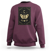 Maroon crewneck sweatshirt with framed moth and moon tarot illustration on the chest