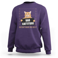 Purple sweatshirt with cat mugshot graphic and 'BAD CATTITUDE' text