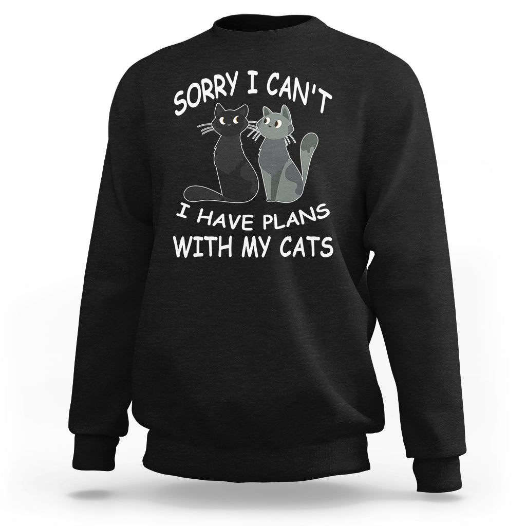 Black cat lover sweatshirt with cat graphic and slogan “Sorry I can’t I have plans with my cats”.
