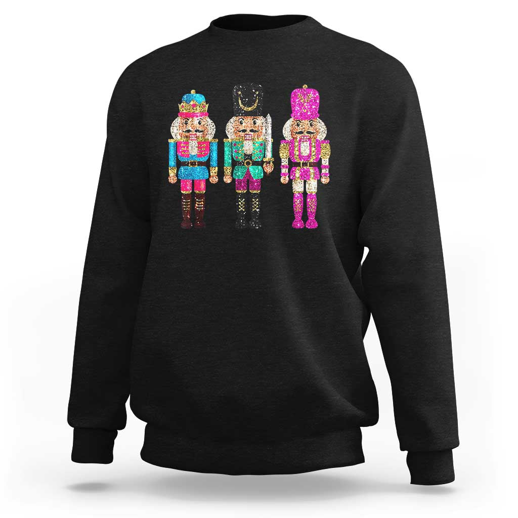 Black crewneck sweatshirt with colorful sequin nutcracker graphic on the chest