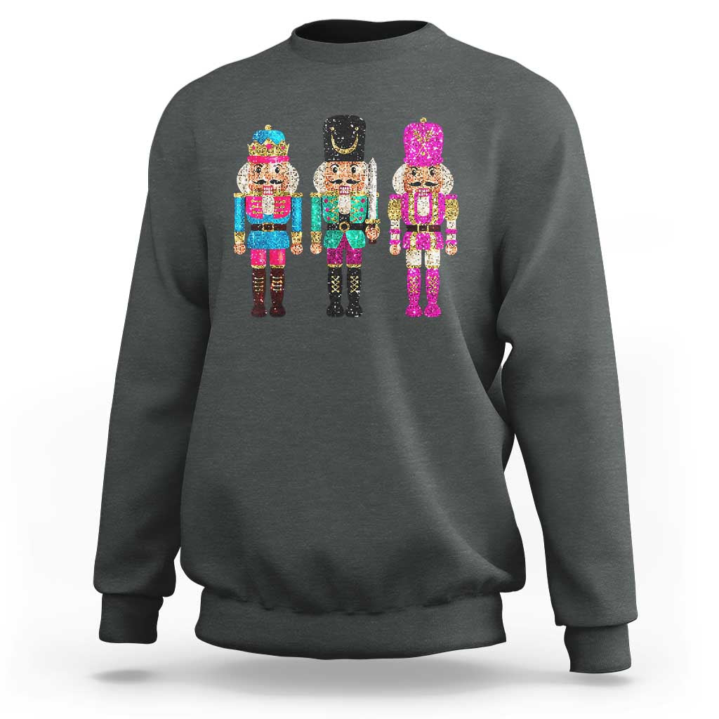 Dark heather crewneck sweatshirt with colorful sequin nutcracker graphic on the chest