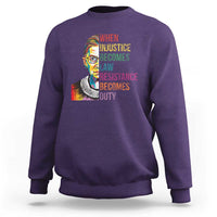 Purple crewneck sweatshirt with RBG-style portrait and resistance quote graphic on front