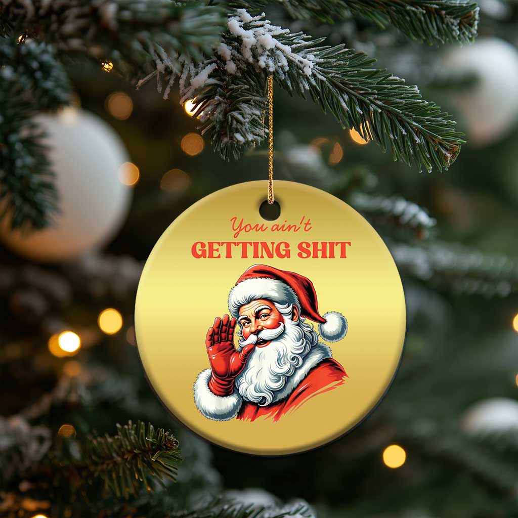 Gold round Santa Christmas ornament with hanging string and “You ain’t getting…” text on tree