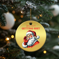 Gold round Santa Christmas ornament with hanging string and “You ain’t getting…” text on tree